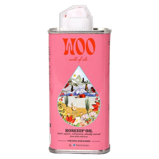 Pink canister of WOO rosehip oil with a colorful label on a white background
