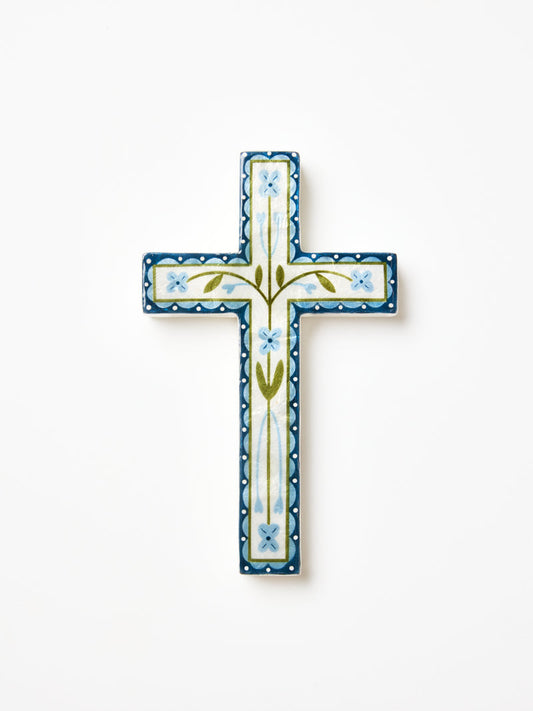 Shell cross with blue green and white flower details. 