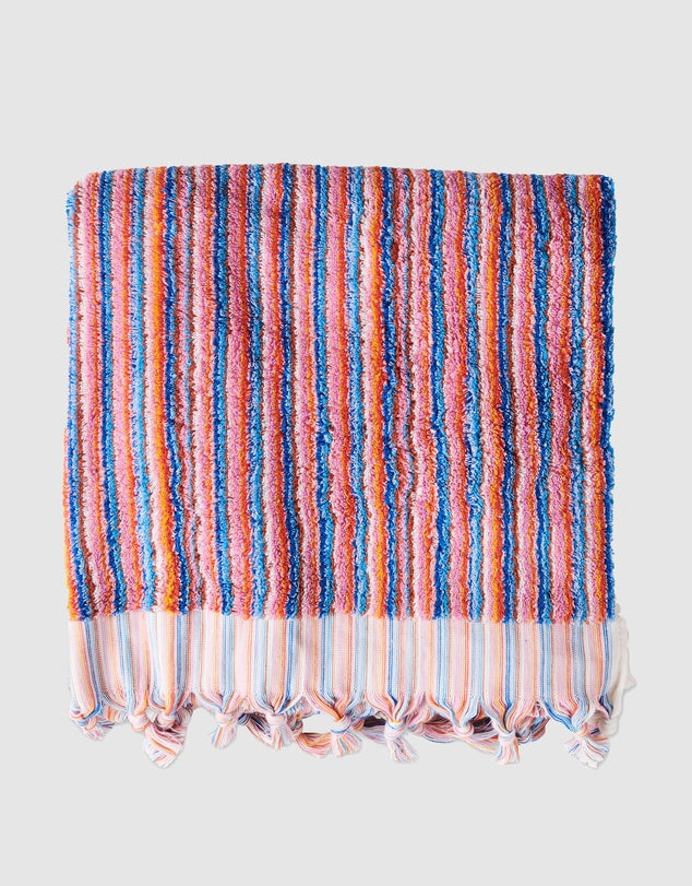 Striped towel with colorful pattern on a light gray background