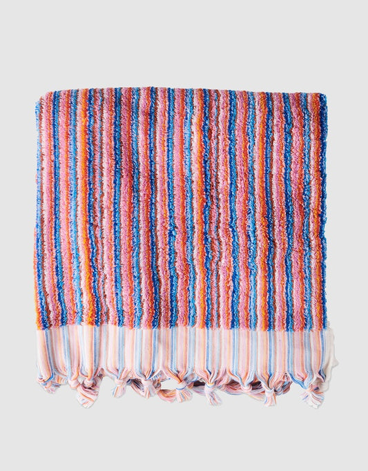 Striped towel with colorful pattern on a light gray background