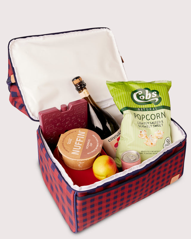  insulated cooler bag with snacks and drinks on a white background