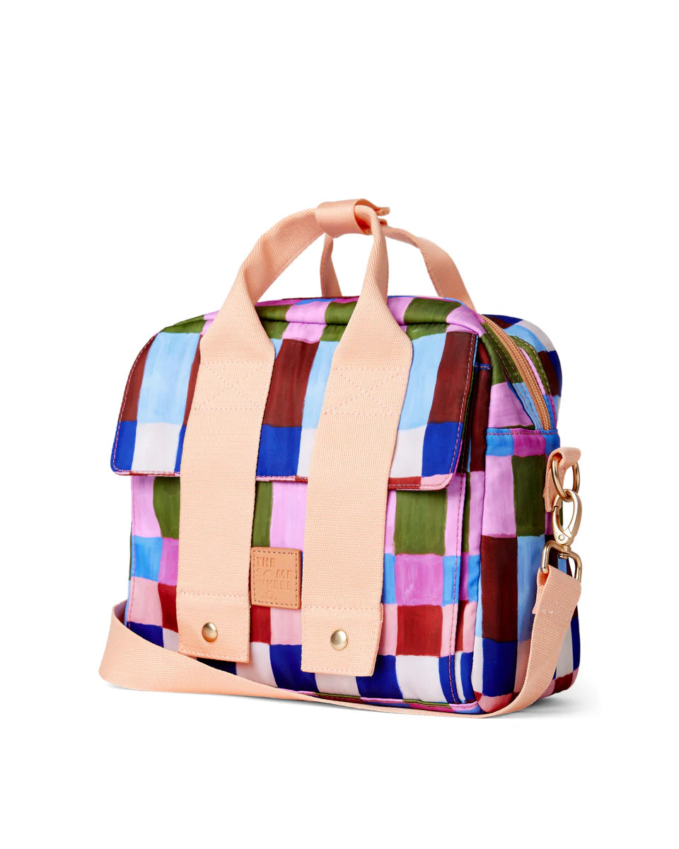 Multicolored checkered bag with beige handles on a white background