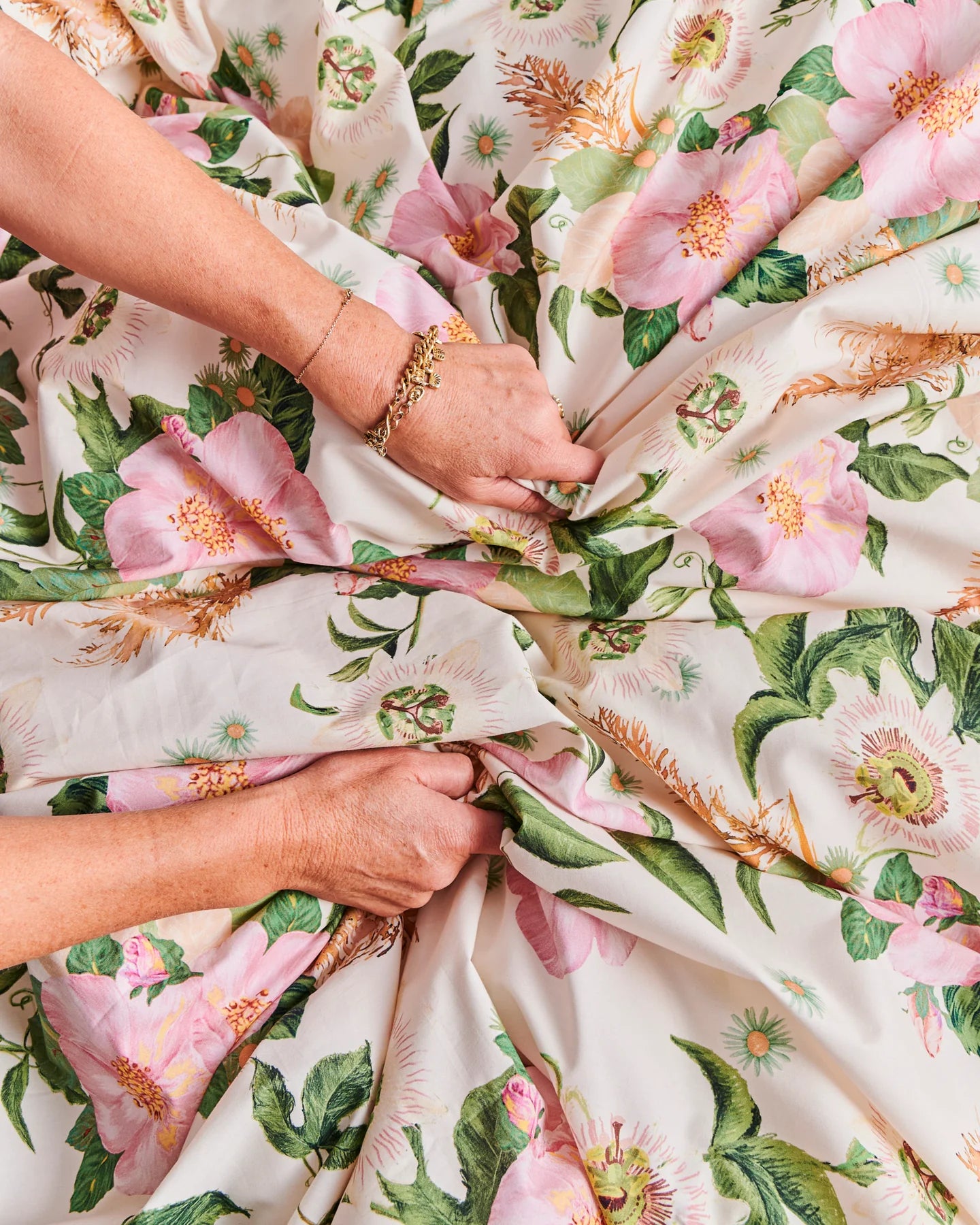 Sunday stroll bed linen scrunched by two hands - probably feeling how soft and lovely the cotton fabric is of this quilt cover. 