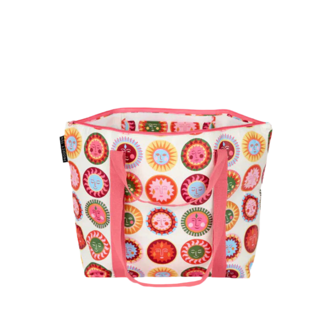 Colorful sun face pattern tote bag with top zip and pink handle on a white background