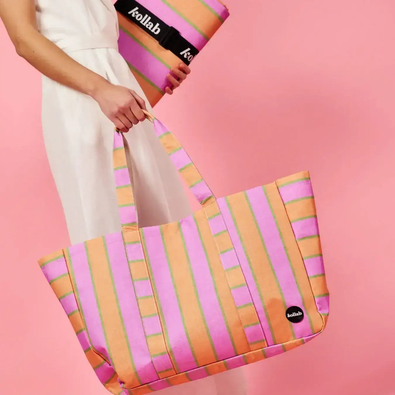 Person holding a colorful striped bag with 'kollab' branding on a pink background