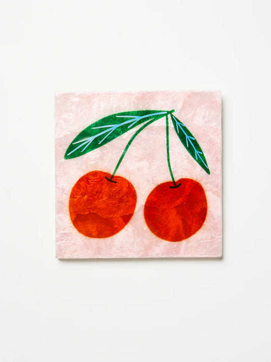 Painting of two red cherries with green leaves on a pink watercolor background