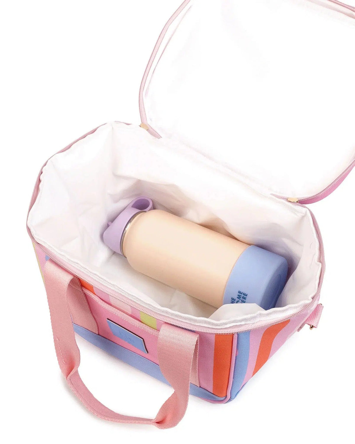 A pastel pink and orange striped soft-sided lunch bag with a white interior, shown open with a reusable insulated bottle inside on a white background.
