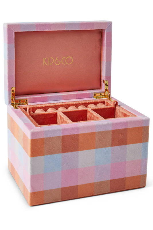 A large velvet jewellery box with a check tartan print in pink, purple, blue, and orange, and a cushioned ring holder inside.