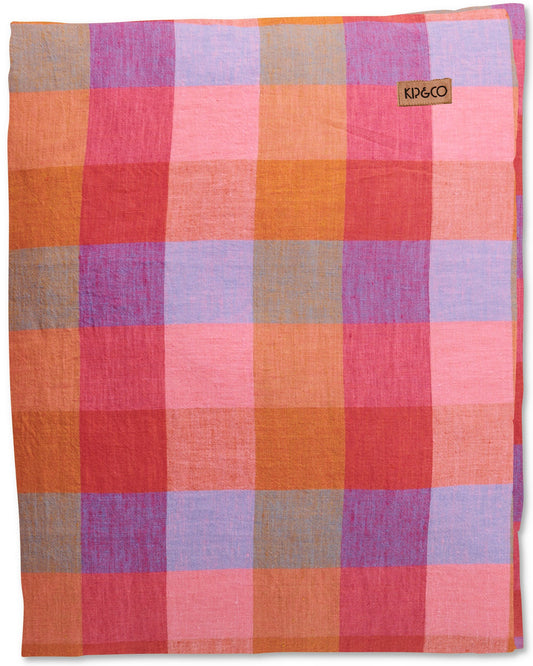 A folded linen tablecloth with a pink, purple, blue, and orange check tartan pattern.