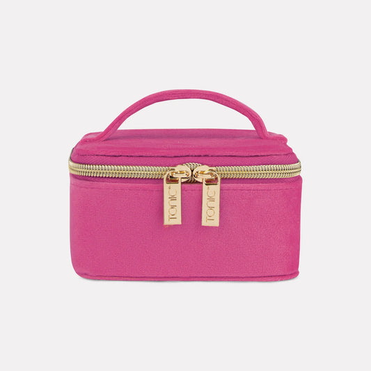 Pink cosmetic bag with gold zipper on a light gray background
