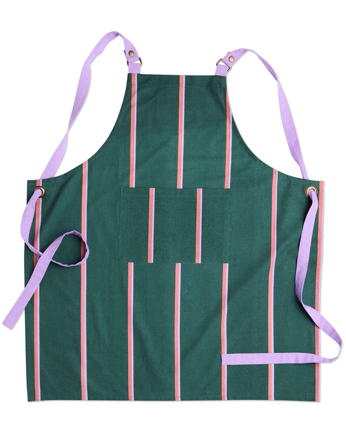 A dark green apron with vertical pink and white stripes, featuring light purple straps and ties, laid flat on a white background.