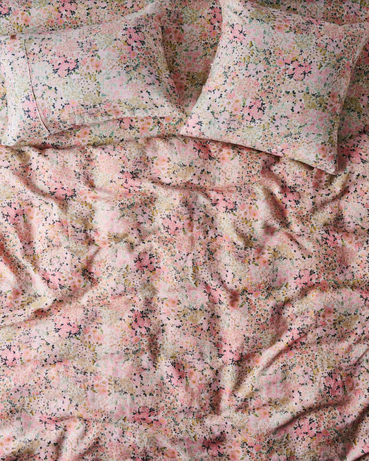 A fitted sheet with a floral pattern in shades of pink and green.
