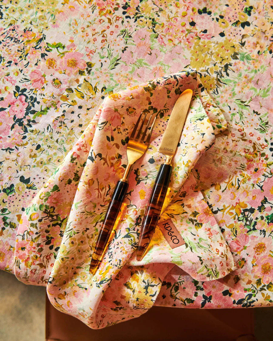 Pink, green and yellow floral tablecloth with matching napkin and cutlery set. 