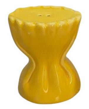 Two yellow ceramic salt and pepper shakers on a white background